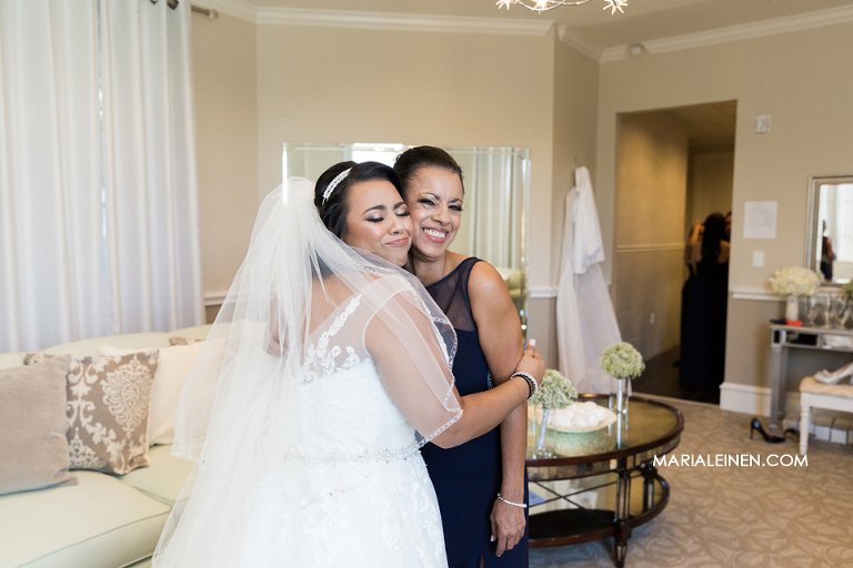 bride hugs her mother after getting dressed for the wedding